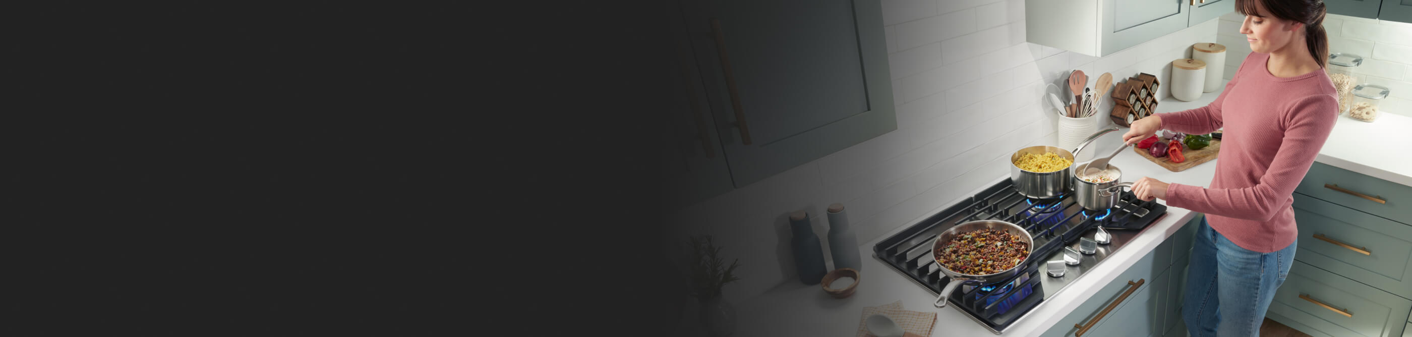 Person stirring dish in a saucepan on a gas cooktop