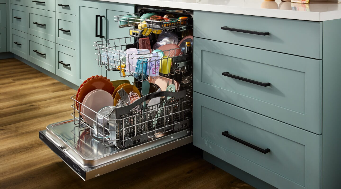 Open and loaded third rack dishwasher in blue cabinetry