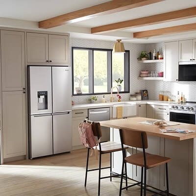 Whirlpool® 4-Door Refrigerator installed in tan cabinetry