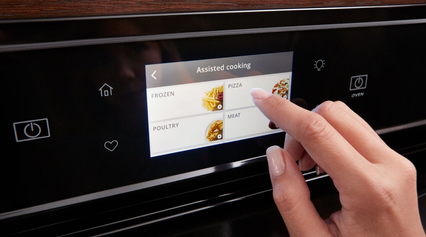 Person touching a Whirlpool® oven touchscreen control panel Person touching a Whirlpool® oven touchscreen control panel