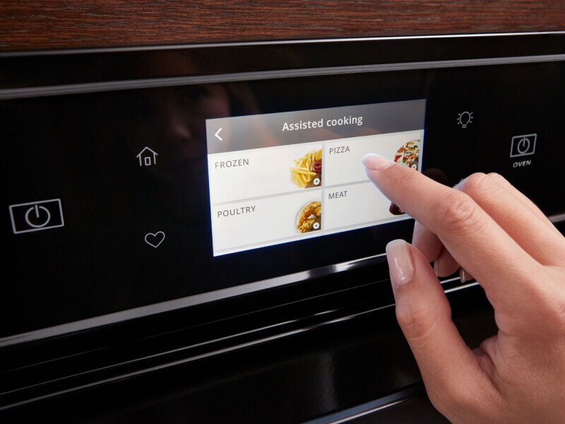 Person touching a Whirlpool® oven touchscreen control panel Person touching a Whirlpool® oven touchscreen control panel