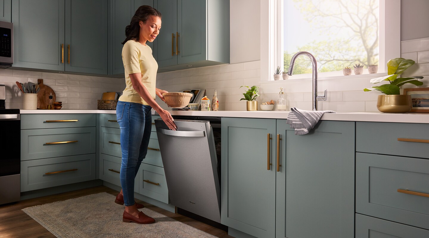 Person closing a top control dishwasher Person closing a top control dishwasher