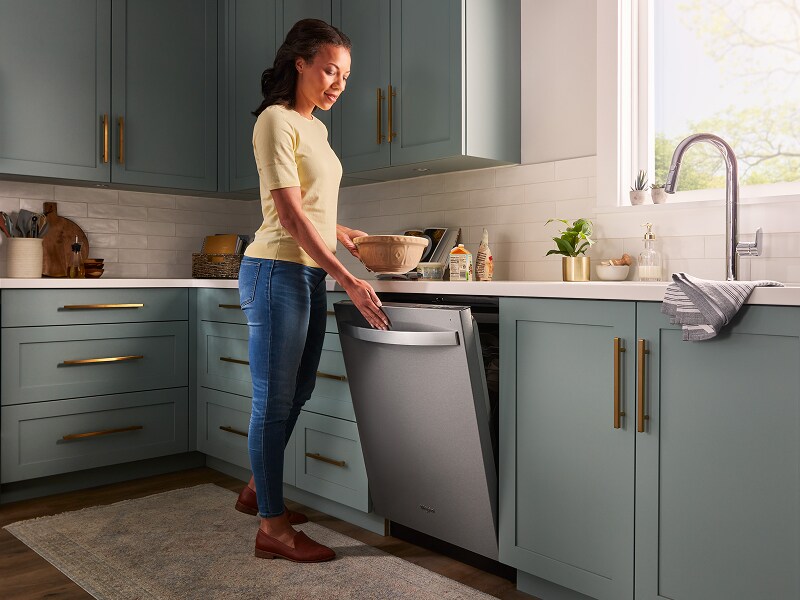 Person closing a top control dishwasher Person closing a top control dishwasher