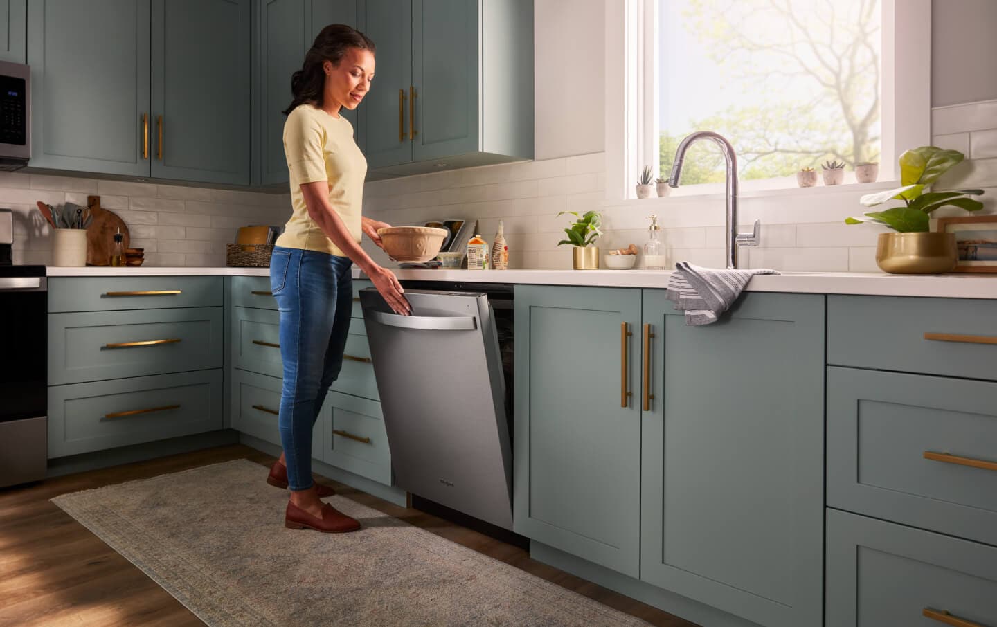 Person closing a Whirlpool® top control dishwasher Person closing a Whirlpool® top control dishwasher