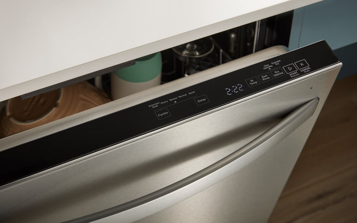 Top control dishwasher open to show control panel