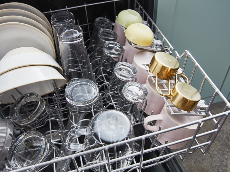 Clean and dried dishes in a dishwasher Clean and dried dishes in a dishwasher