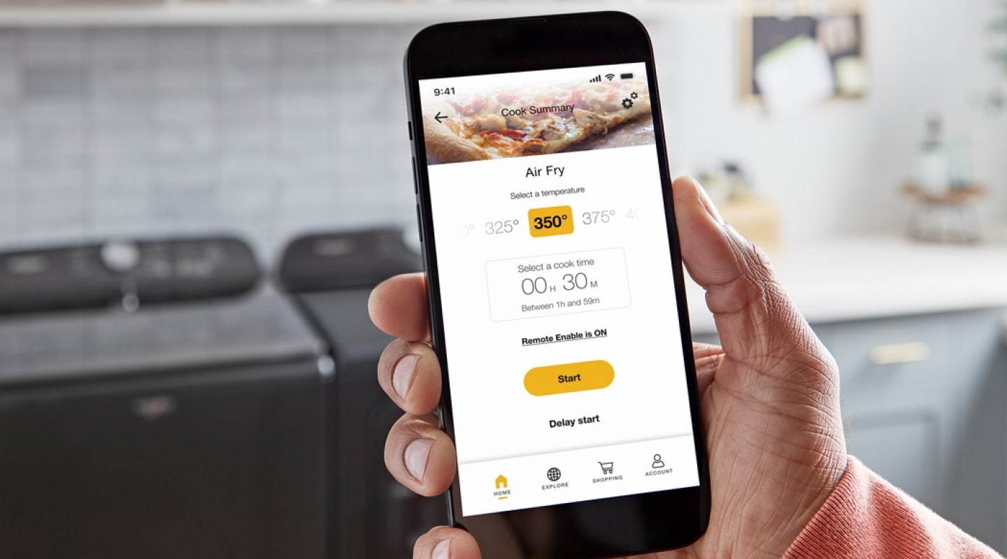 Person using a smartphone to monitor air fry temperatures in their Smart Microwave Oven from Whirlpool brand Person using a smartphone to monitor air fry temperatures in their Smart Microwave Oven from Whirlpool brand