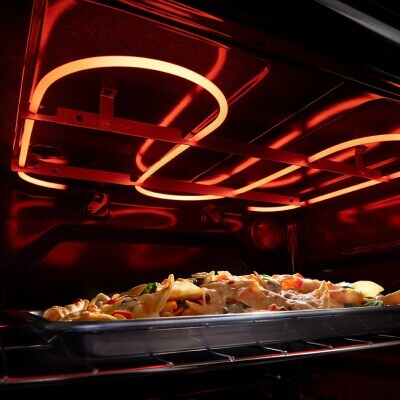 Top oven heating element baking food inside the oven