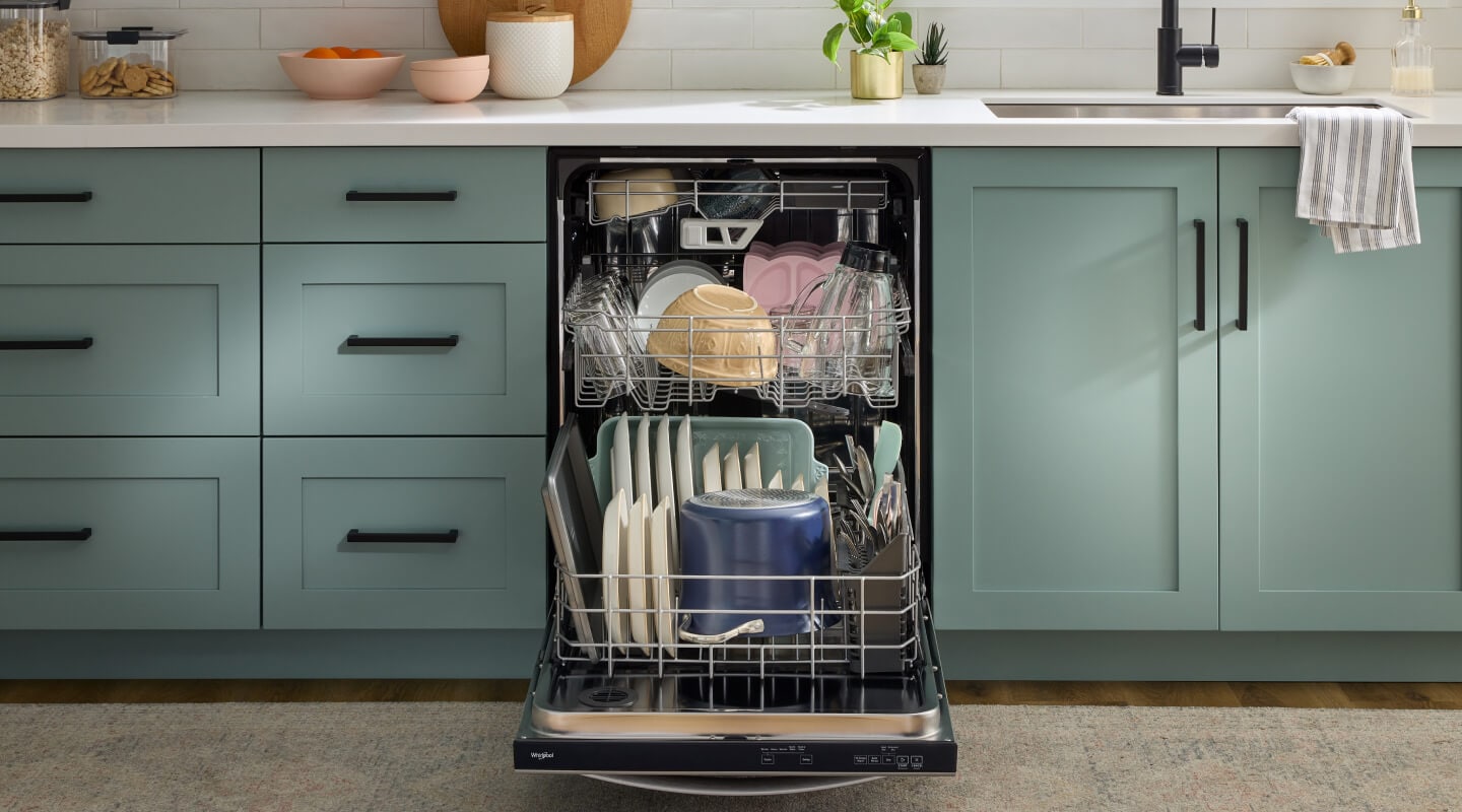 A close-up of an open dishwasher in a modern kitchen