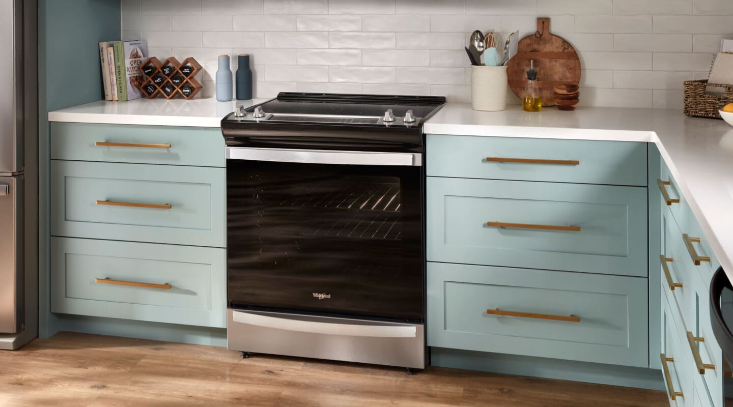 Whirlpool® 6.4 Cu. Ft. Electric 7-in-1 Air Fry Oven set in blue cabinetry
