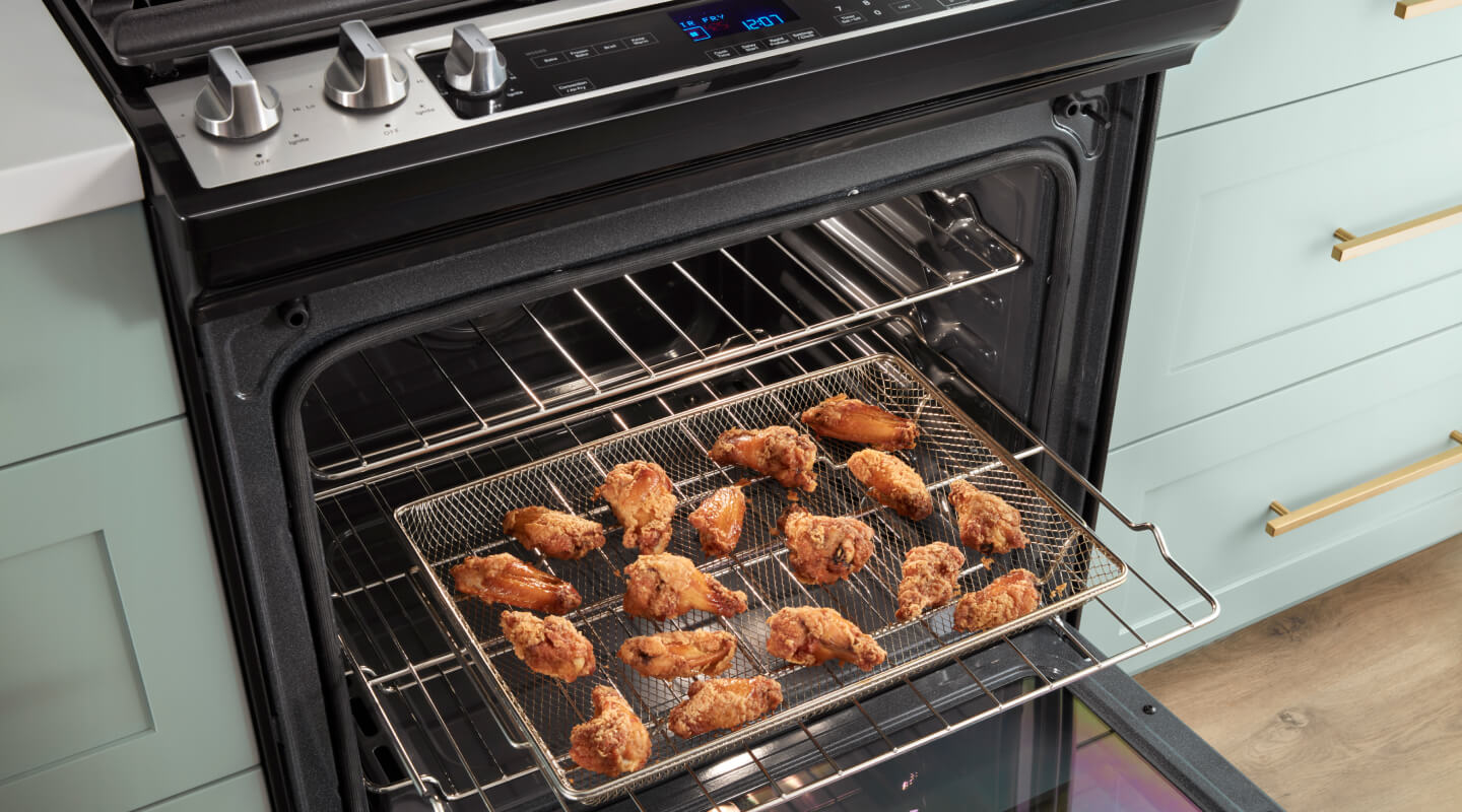 Air fried chicken wings in an open oven
