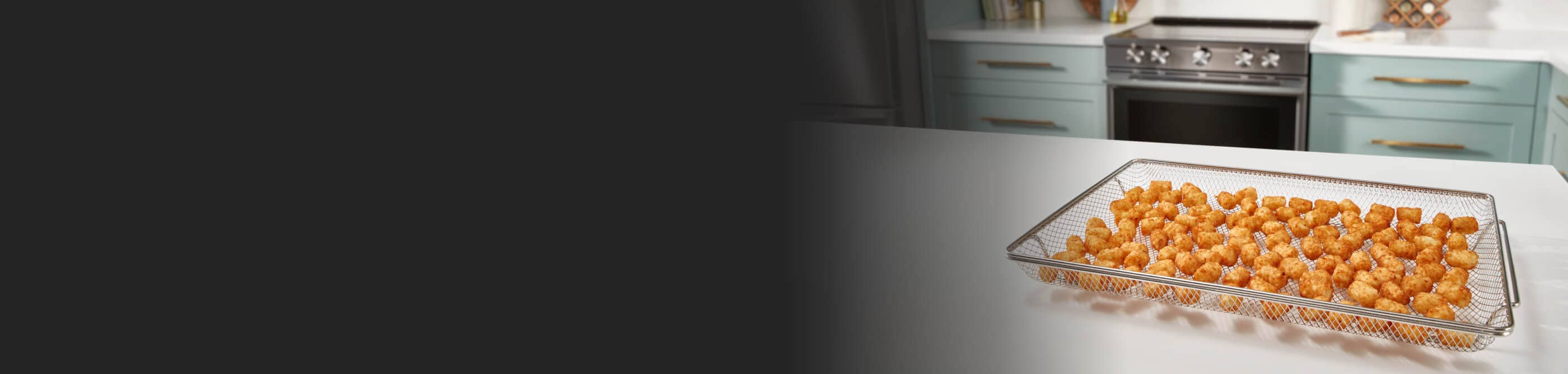 Air fried tater tots on counter by air fryer oven