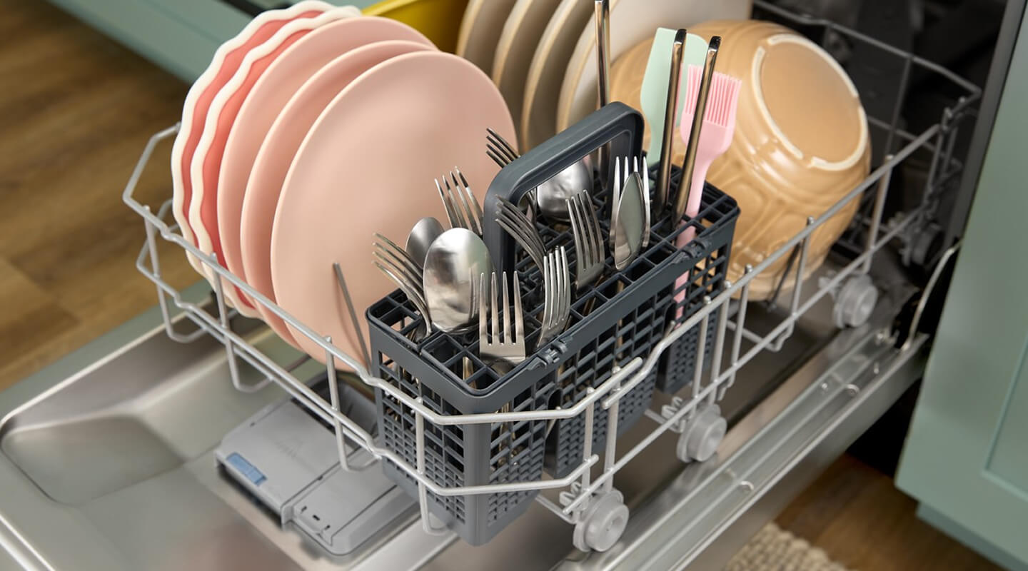 An open Whirlpool® Dishwasher with dishes inside