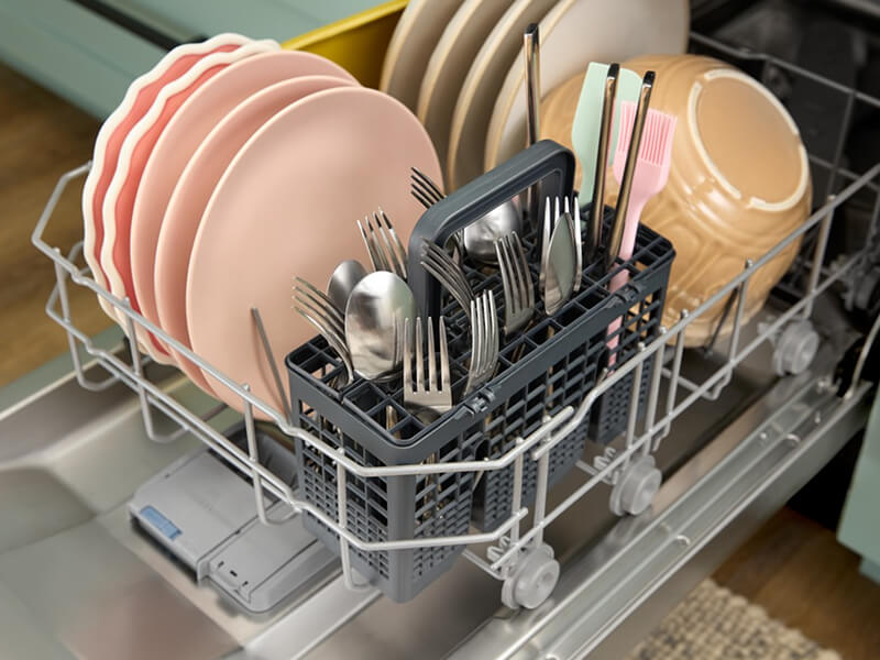An open Whirlpool® Dishwasher with dishes inside