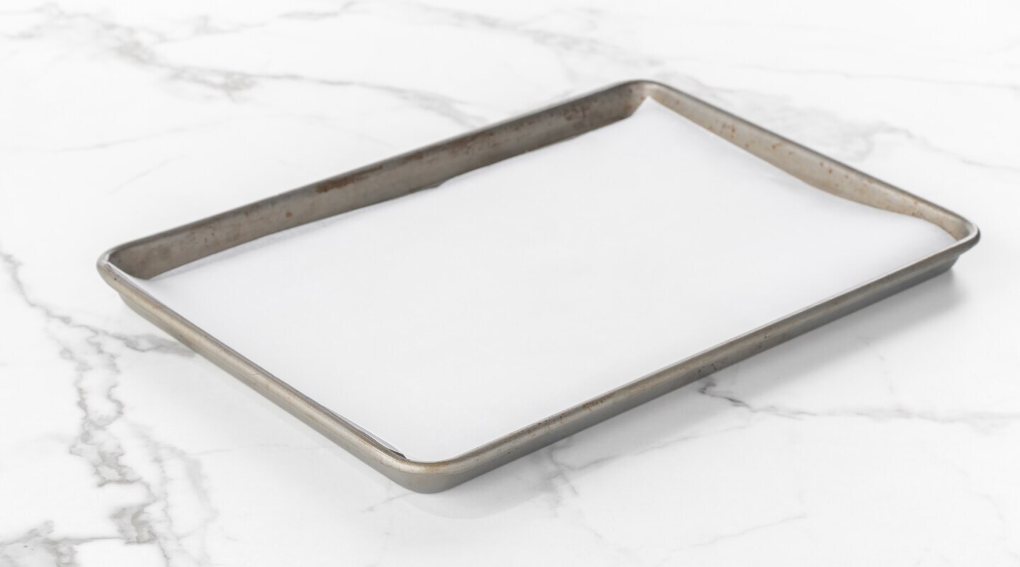 Baking sheet lined with parchment paper Baking sheet lined with parchment paper