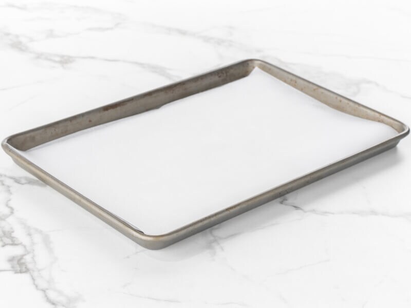 Baking sheet lined with parchment paper Baking sheet lined with parchment paper
