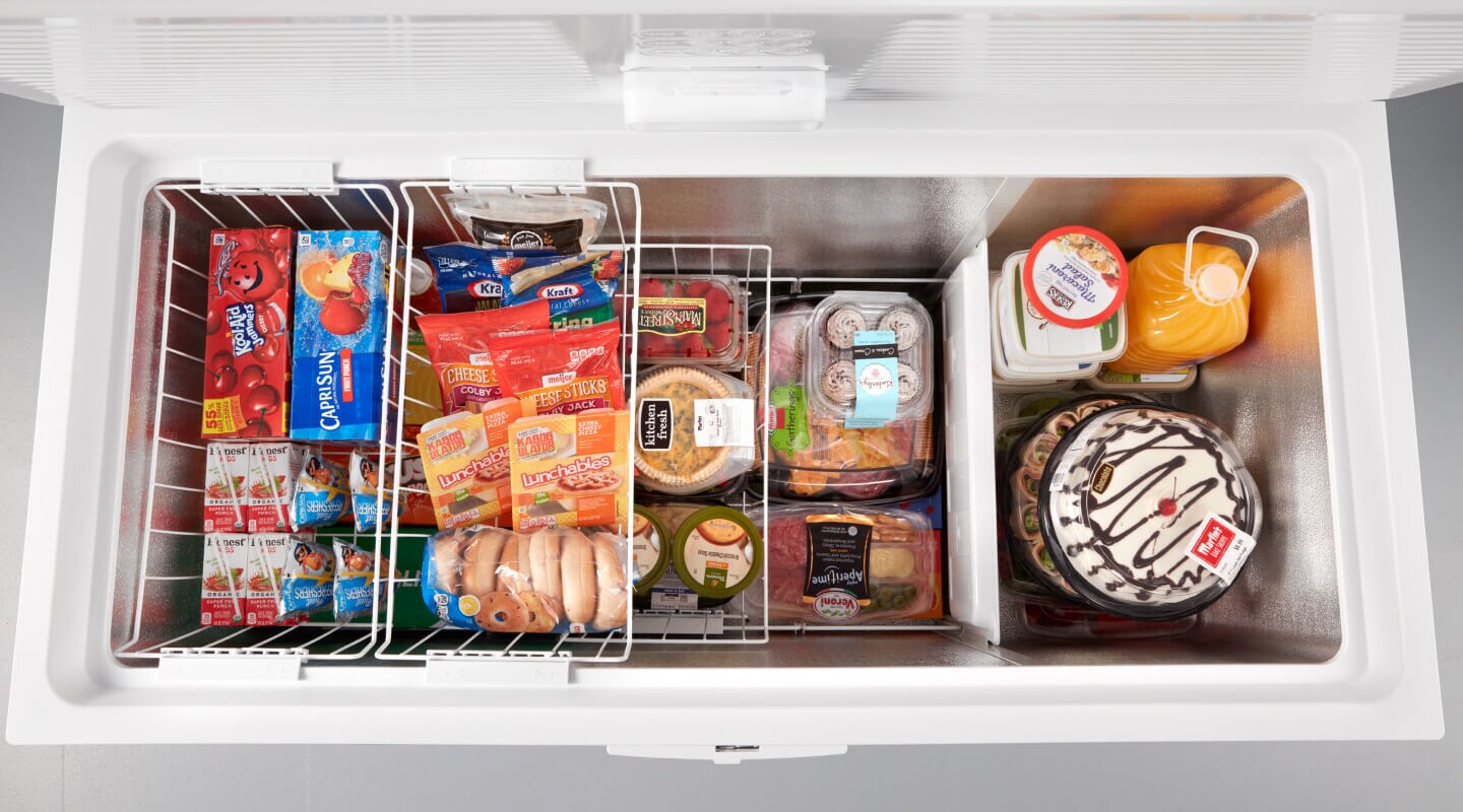 Open chest freezer filled with frozen food