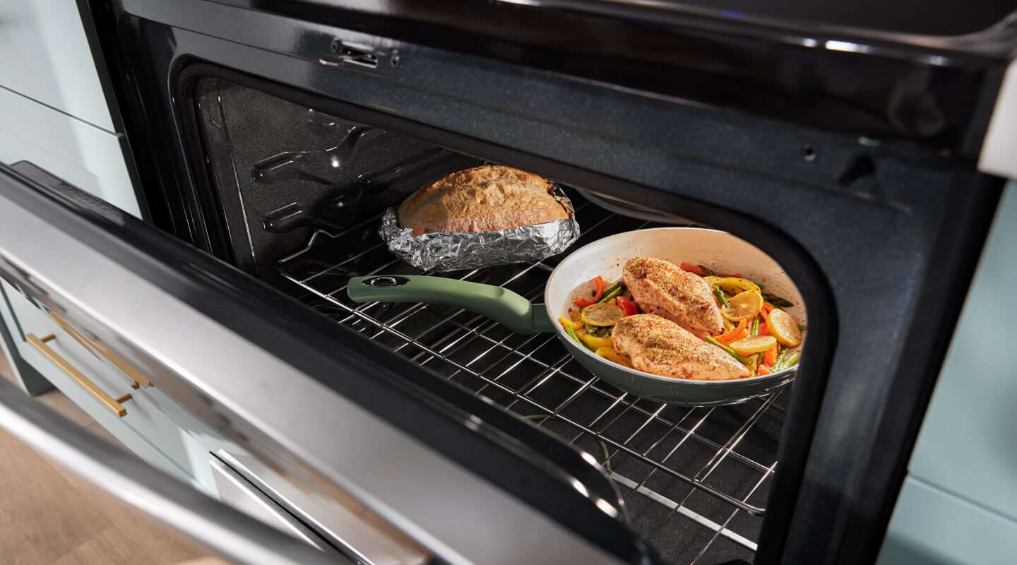 One pan meal and bread inside an oven One pan meal and bread inside an oven