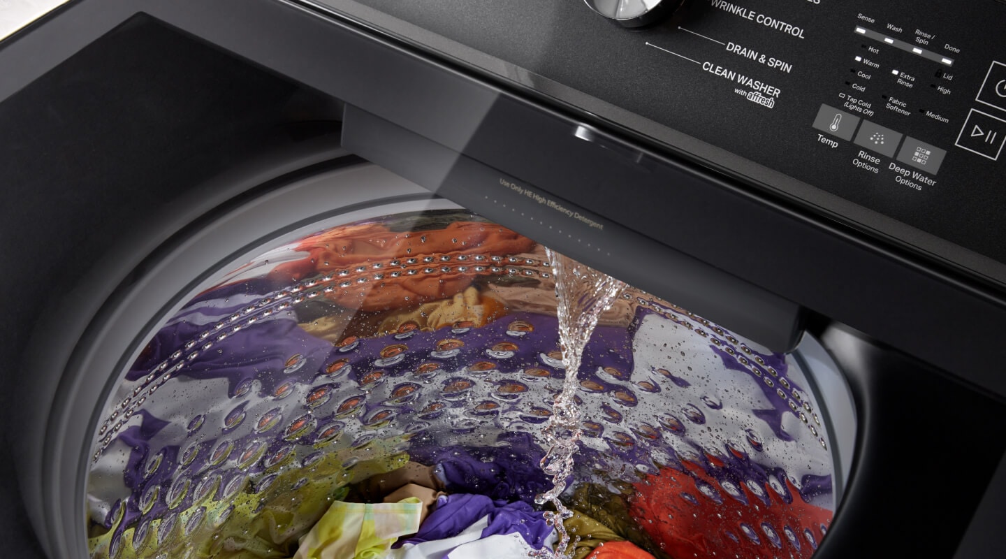 Water pouring into a washing machine Water pouring into a washing machine