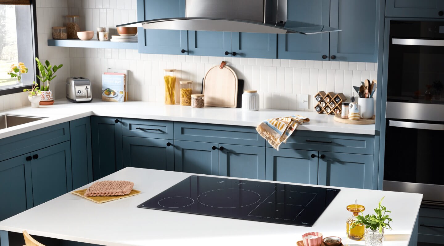 A kitchen with an induction cooktop on an island