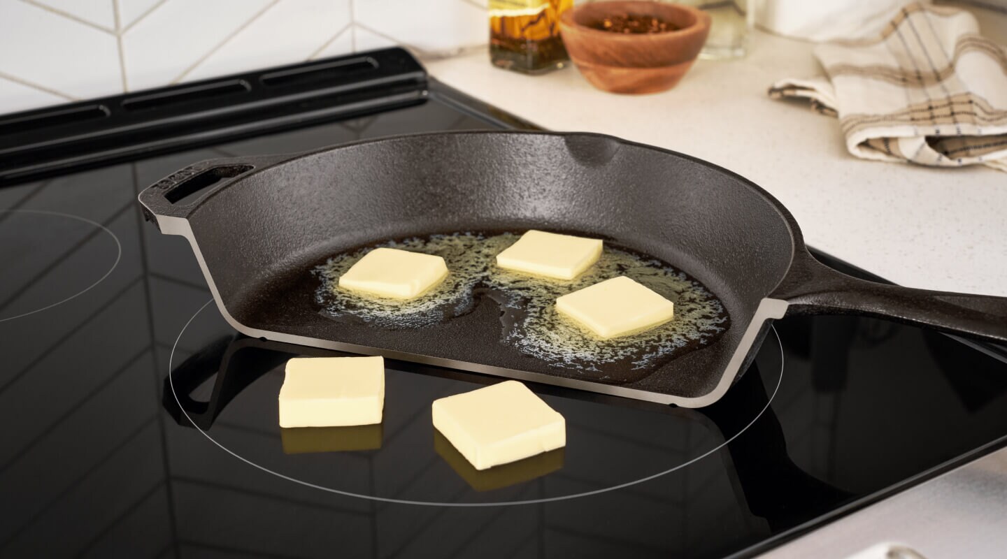 A photo illustration of butter melting in a pan but not melting when placed directly on top of an induction cooktop