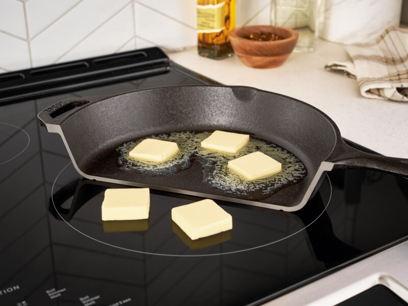 A photo illustration of butter melting in a pan but not melting when placed directly on top of an induction cooktop