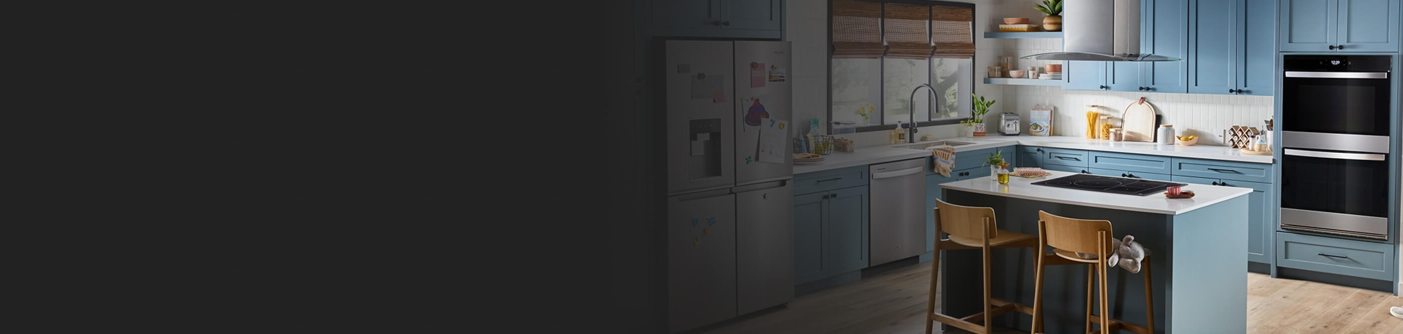 a beautiful kitchen in blue tones with stainless steel appliances and an island