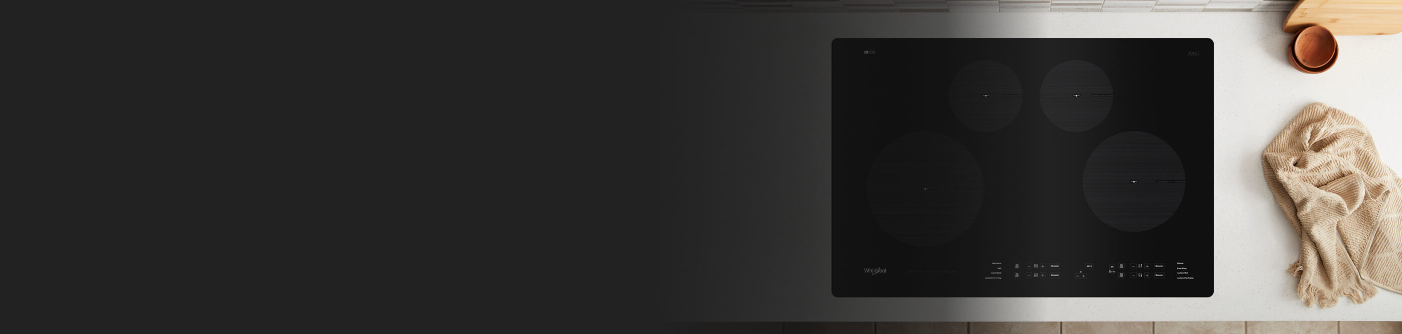  Whirlpool® Electric Cooktop next to kitchen towel on countertop