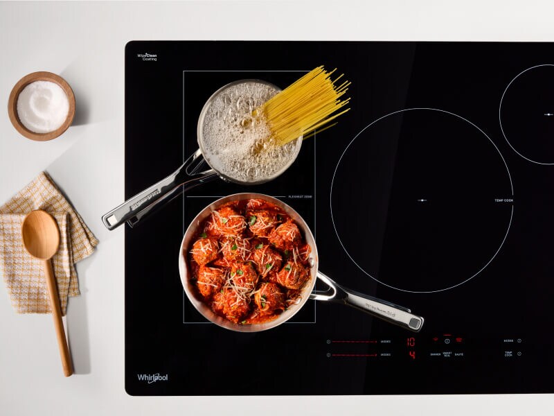 Noodles and meatball cooking on an induction cooktop Noodles and meatball cooking on an induction cooktop
