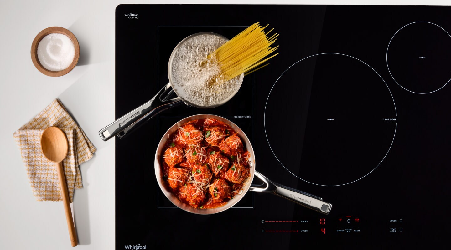 Noodles and meatball cooking on an induction cooktop Noodles and meatball cooking on an induction cooktop