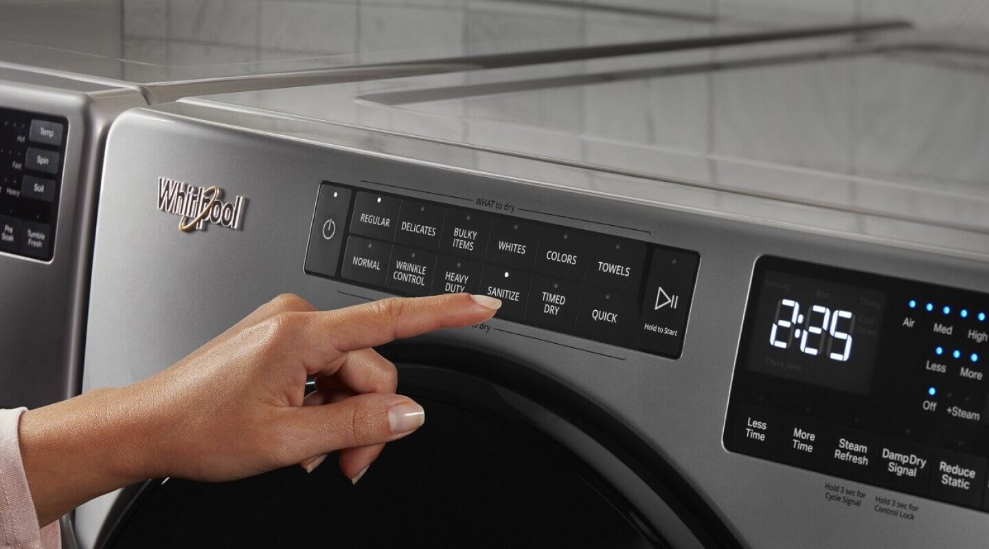 Person selecting a cycle on a Whirlpool® Dryer