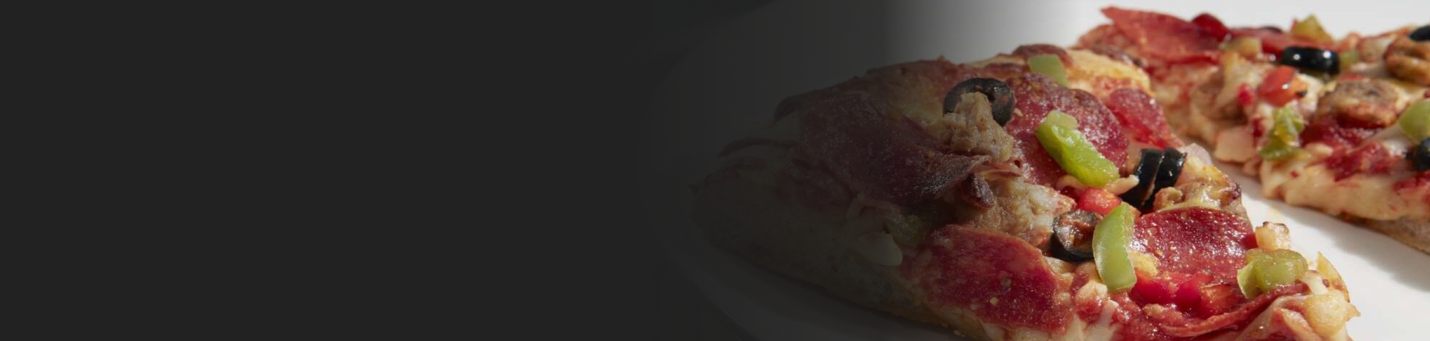 Close-up of a slice of pizza with assorted toppings