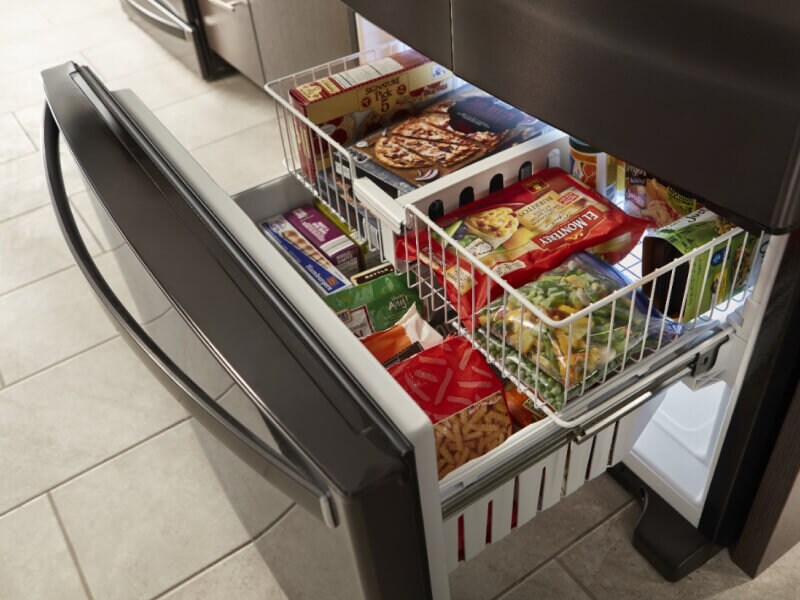An open drawer on a bottom-freezer refrigerator An open drawer on a bottom-freezer refrigerator