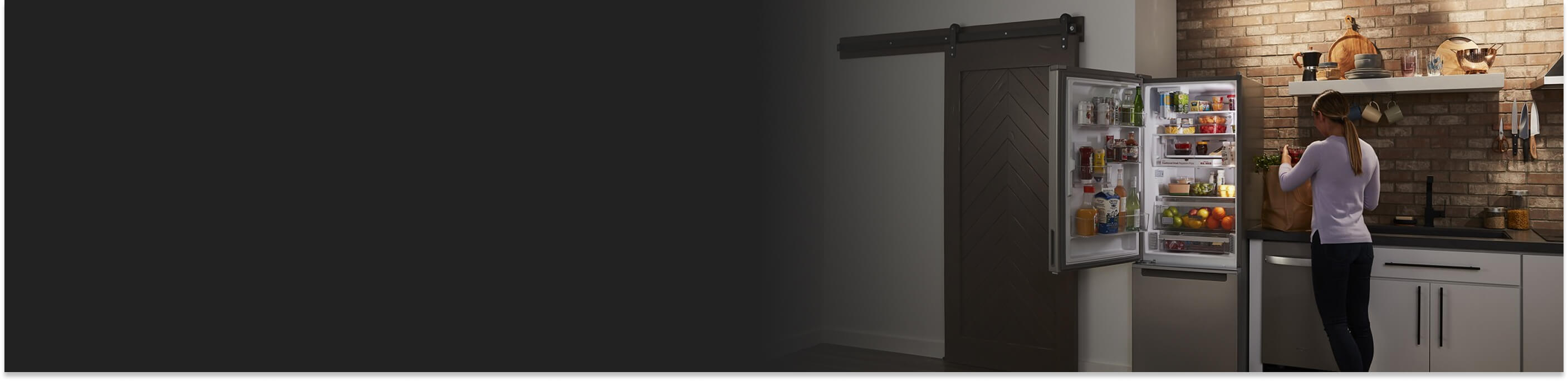 A woman next to a bottom-freezer fridge