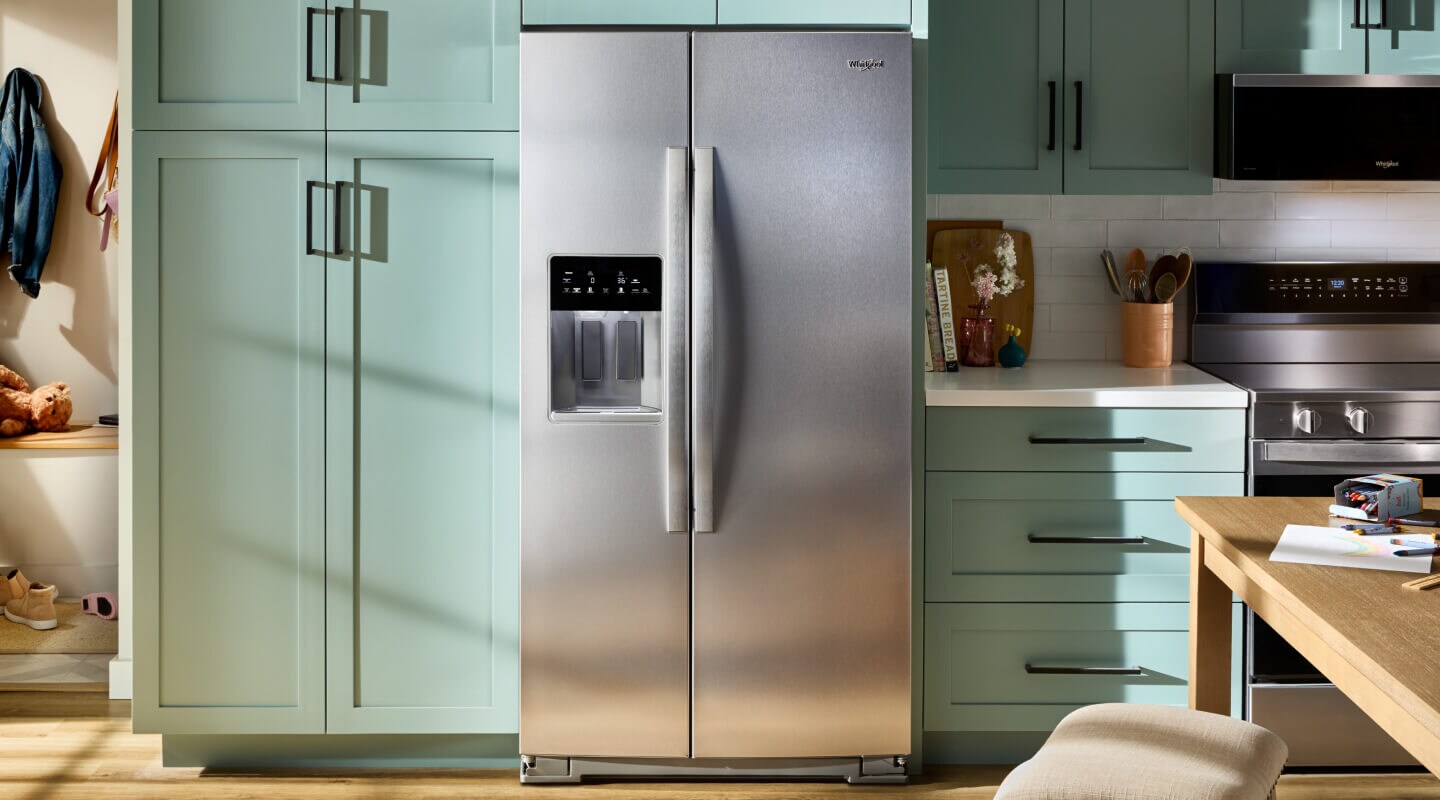 Whirlpool® side-by-side refrigerator in mint green cabinetry