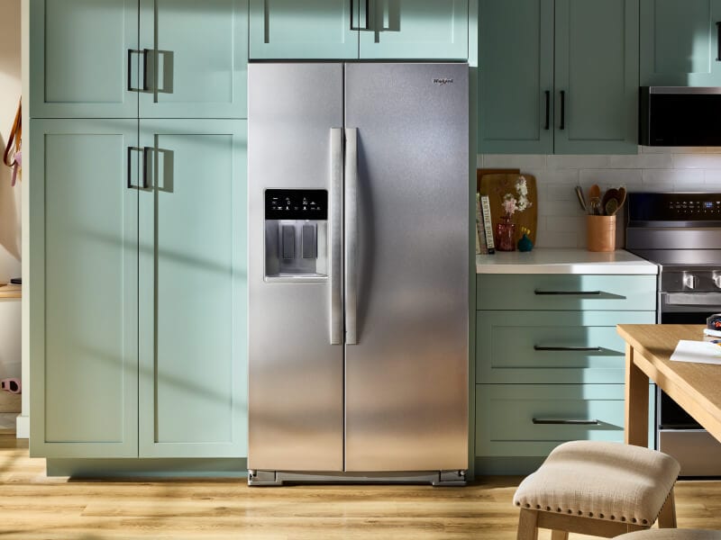 Whirlpool® side-by-side refrigerator in mint green cabinetry