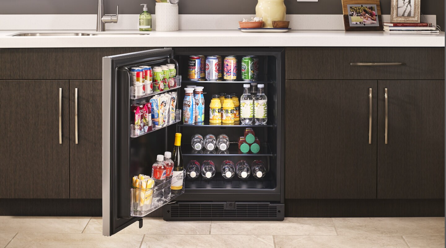 Undercounter refrigerator in brown cabinetry