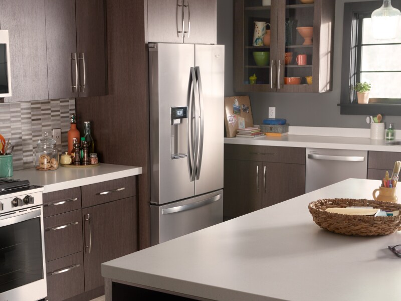 A stainless steel Whirlpool® french door fridge in a kitchen A stainless steel Whirlpool® french door fridge in a kitchen