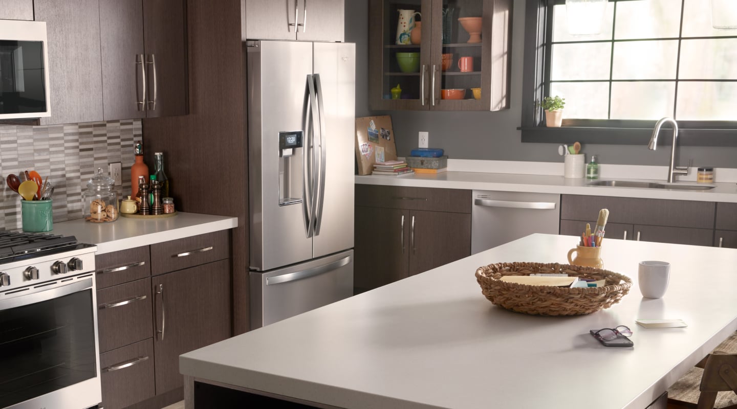 A stainless steel Whirlpool® french door fridge in a kitchen A stainless steel Whirlpool® french door fridge in a kitchen