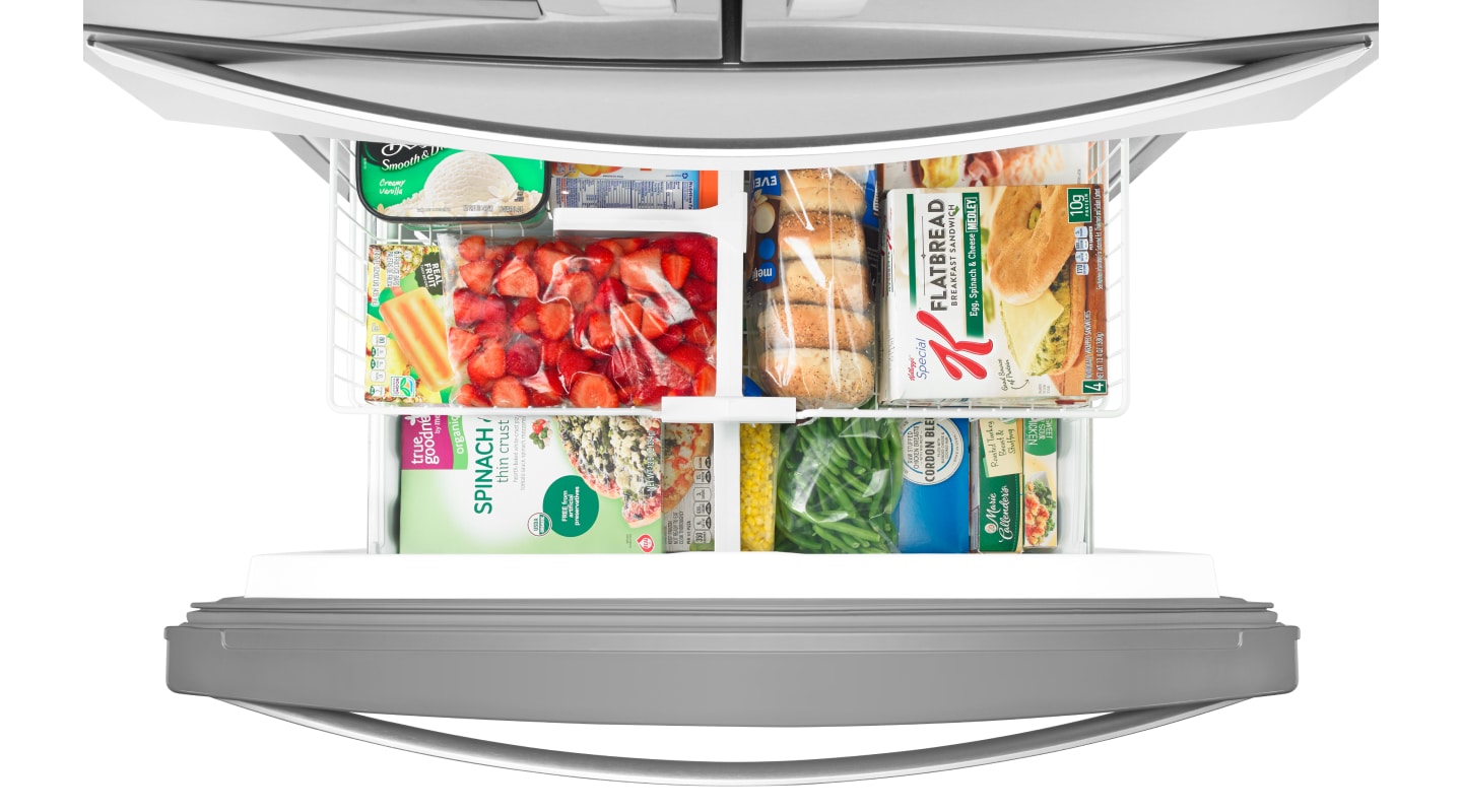 An open fridge freezer compartment An open fridge freezer compartment