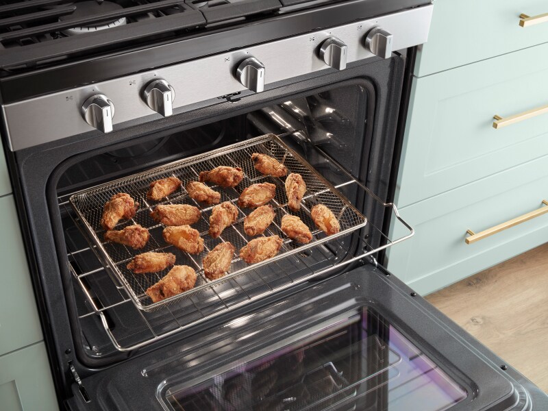 Wings on the Air Fryer Basket inside a Whirlpool® Gas Range Wings on the Air Fryer Basket inside a Whirlpool® Gas Range