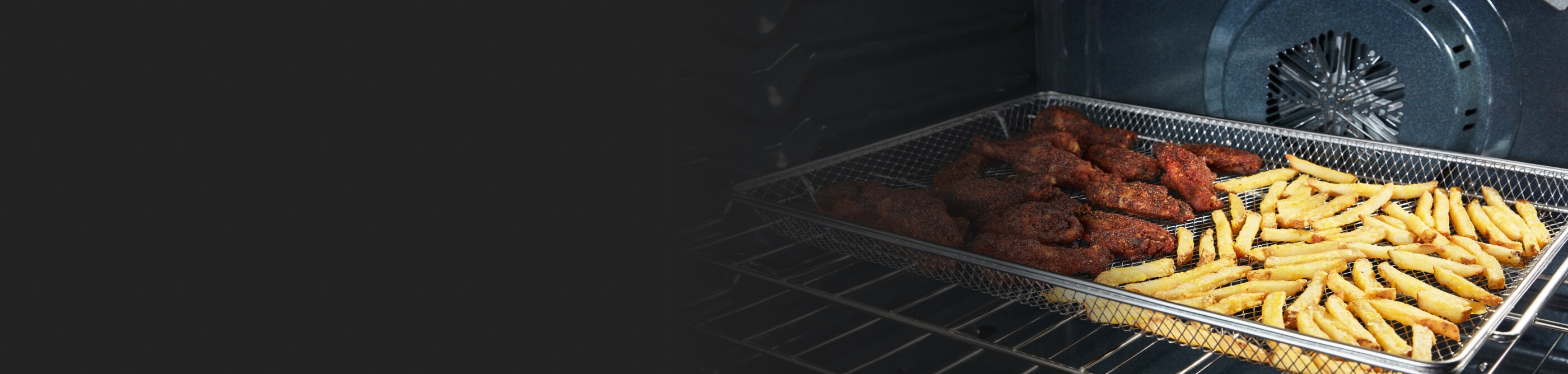 Chicken and fries in an air fryer basket