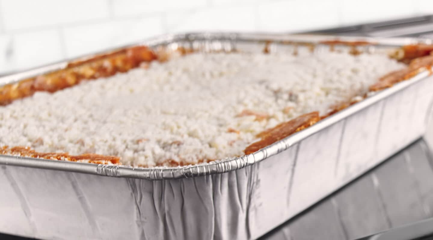 Lasagna in a foil pan getting ready to cook in the oven Lasagna in a foil pan getting ready to cook in the oven