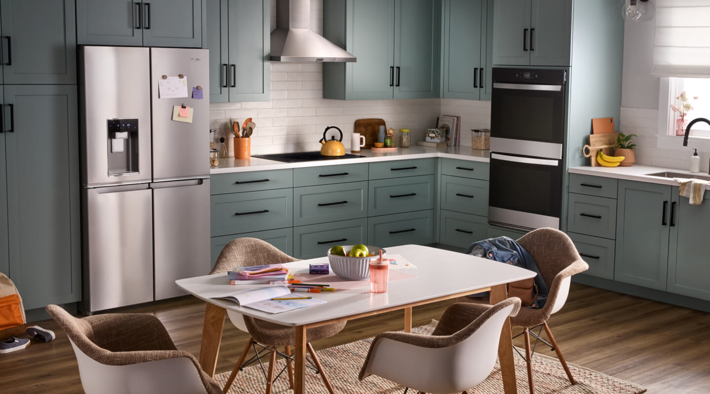 A kitchen with stainless steel appliances and a double wall oven