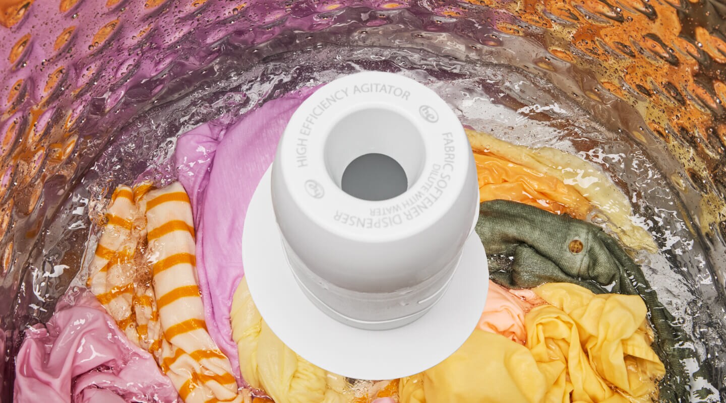 Clothes in a washer with an agitator Clothes in a washer with an agitator
