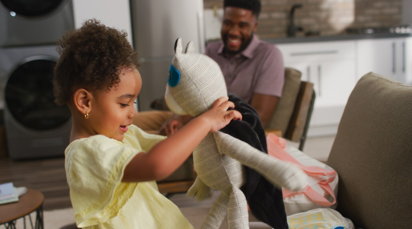 Child playing with a stuffed toy Child playing with a stuffed toy