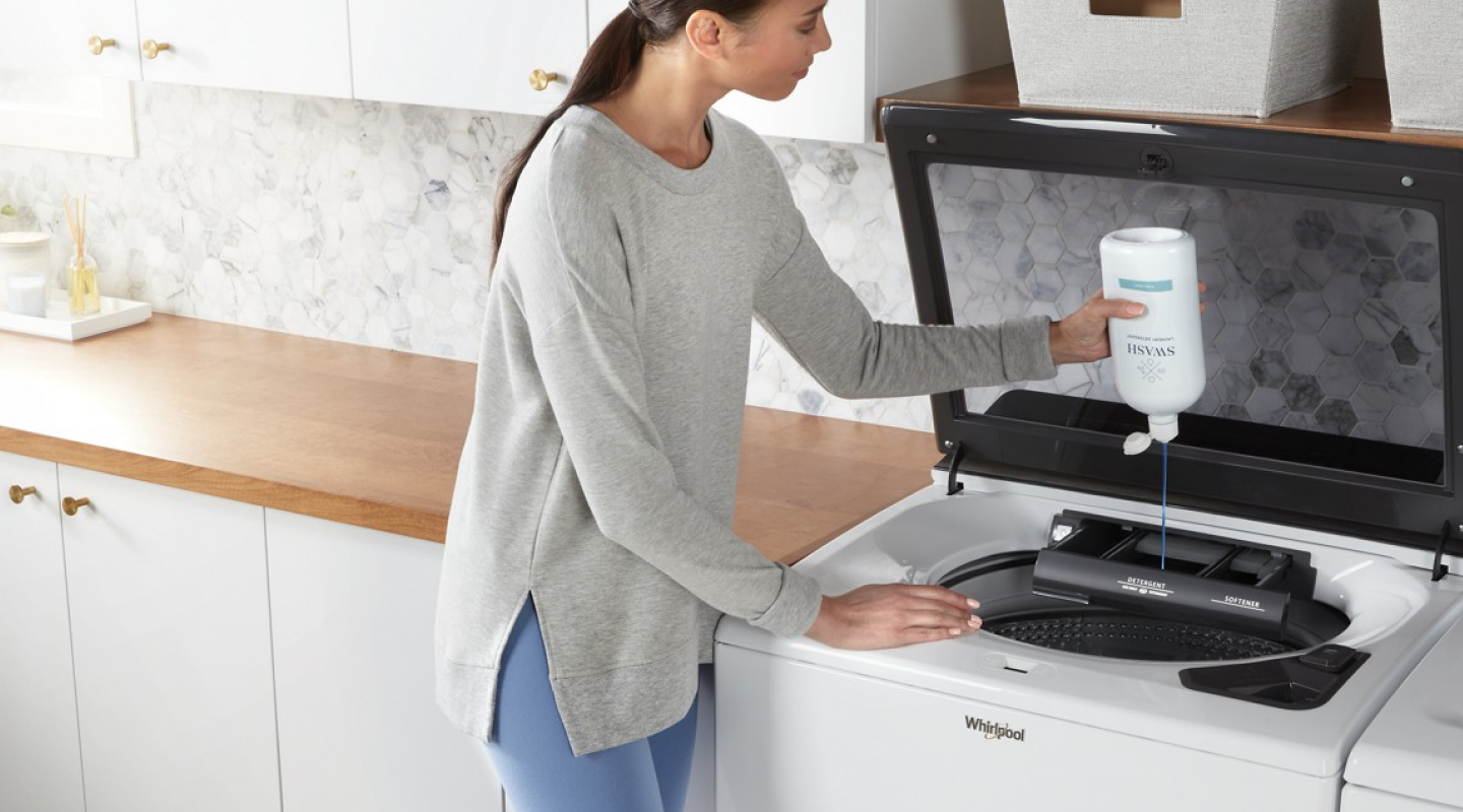 A person pouring Swash® Laundry Detergent into the dispenser of a white Whirlpool® Top Load Washer A person pouring Swash® Laundry Detergent into the dispenser of a white Whirlpool® Top Load Washer