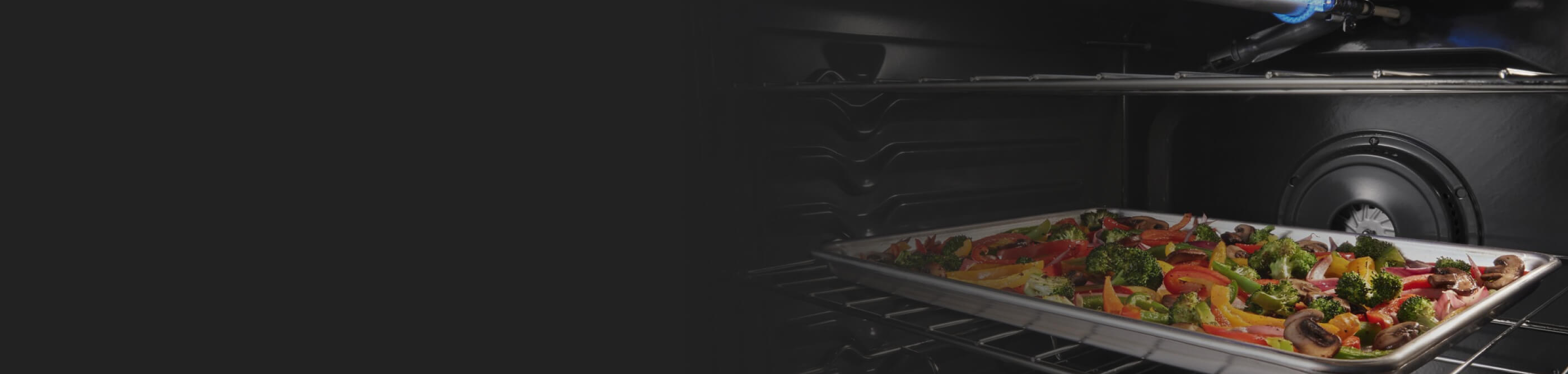 Veggies roasting on a pan in a convection oven