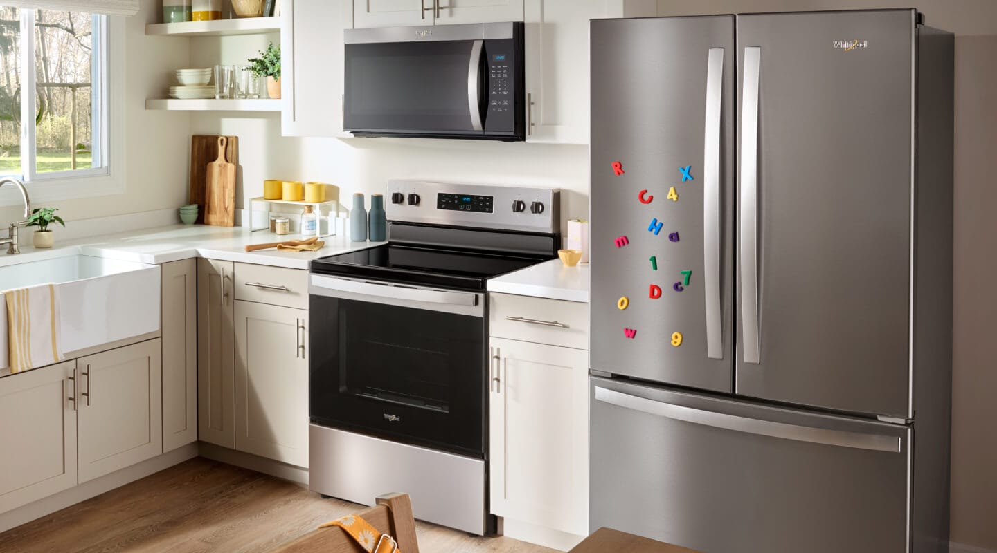 A Whirlpool® refrigerator, oven and microwave in a kitchen