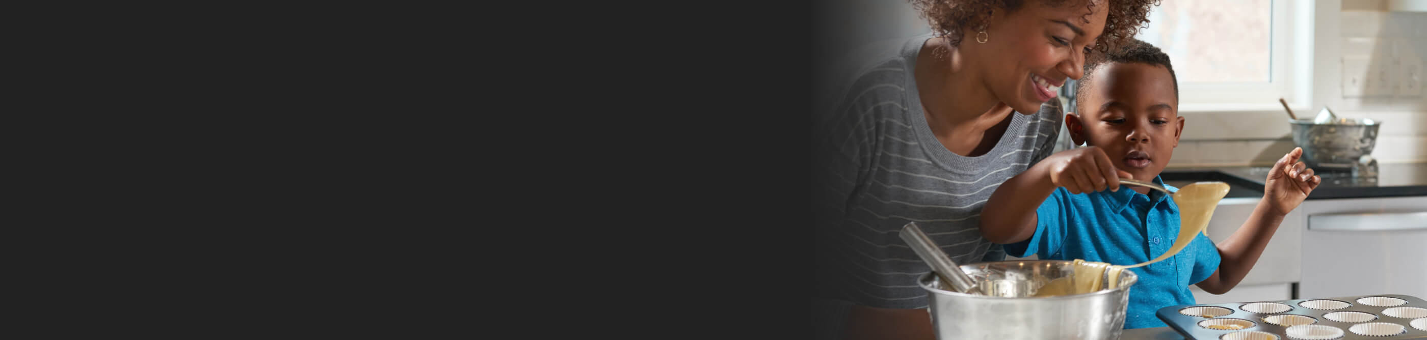 A woman and toddler cooking together in a kitchen